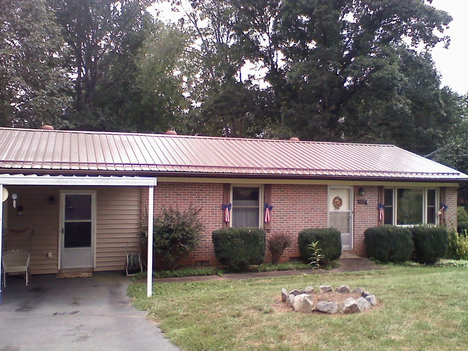 Bronze metal roof and carport on a brick ranch home — Roof Repair work by our crew in South Carver