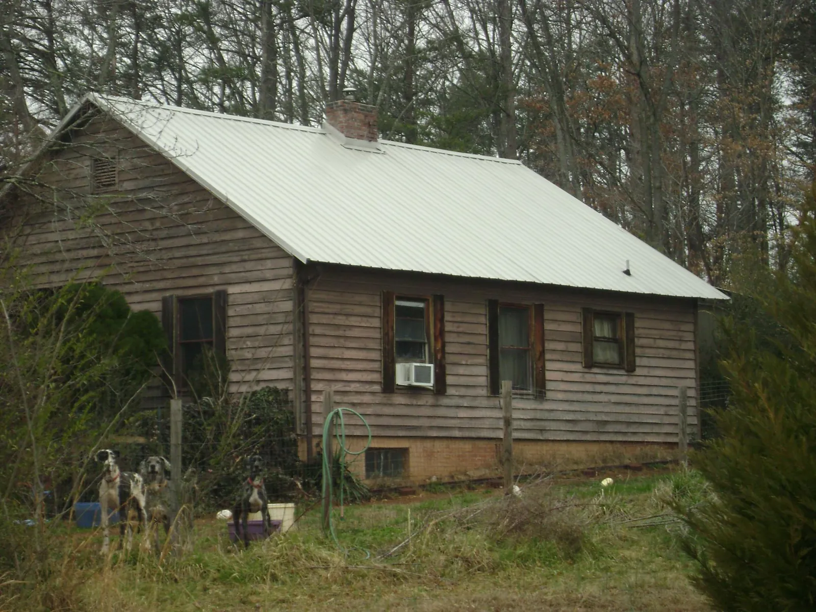 White metal roof on an old wood sided farmhouse, from a Metal Roof Installation job in South Carver